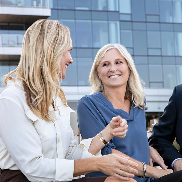 Kati-and-Michelle-Smiling-Talking-City-Background-600x600