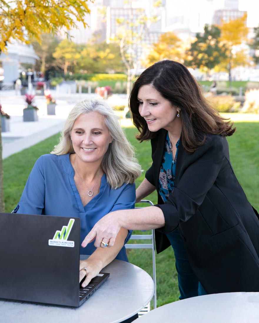 Michelle-and-Lara-outside-working-on-laptop-880x1100